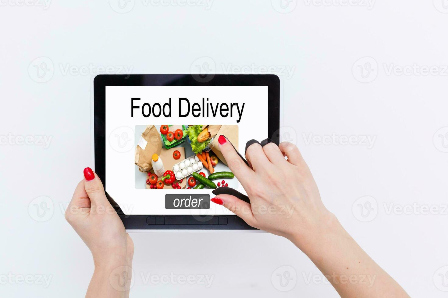 Girl ordering pizza online on smartphone, with table and coffee and plant in background photo