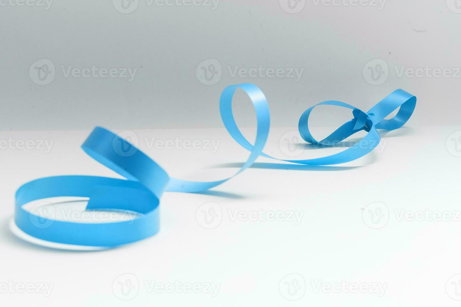 Shiny satin ribbon on white background photo