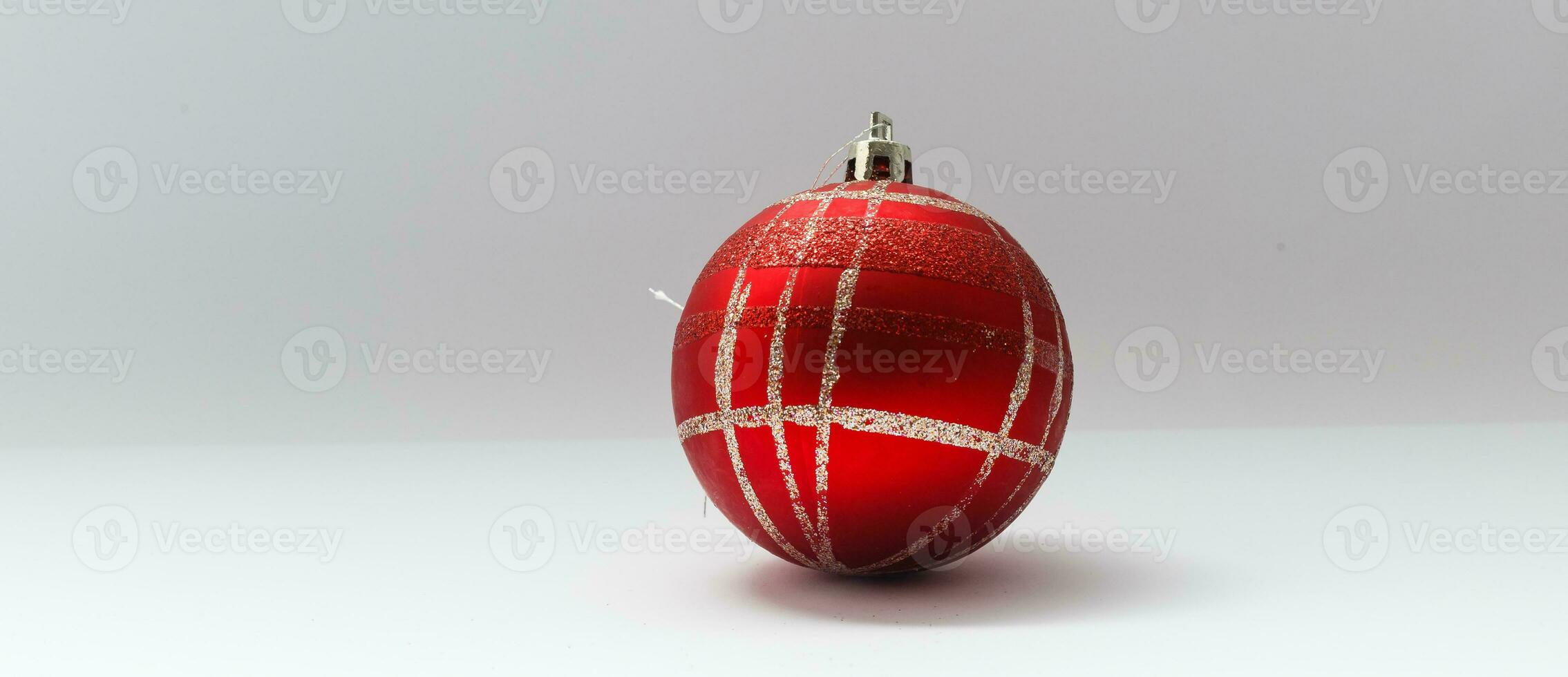 Single red Christmas tree ball decoration isolated over the white background, photo