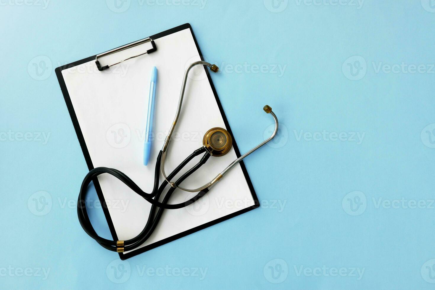 phonendoscope with tablet and pen on blue background with copy space, medical background photo