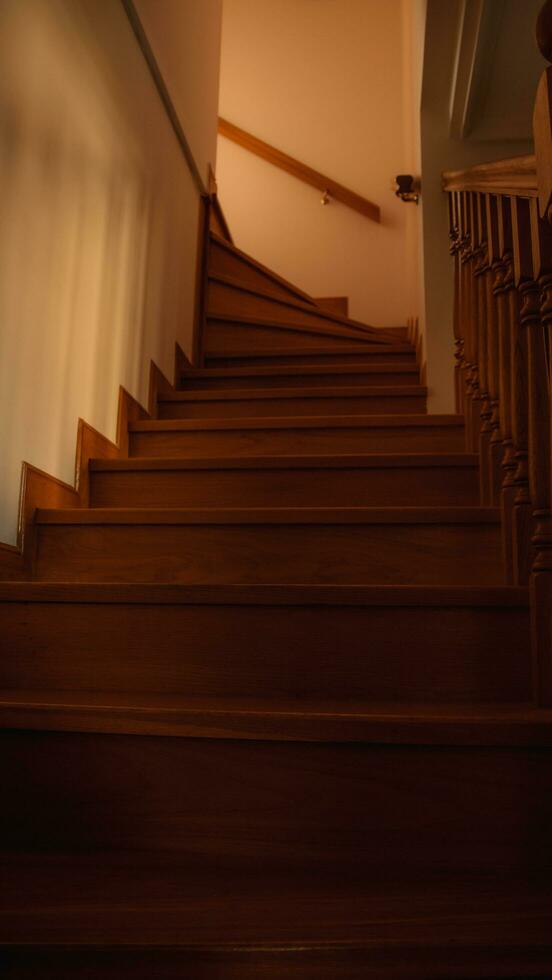 Stairs in a house with a wooden railing photo