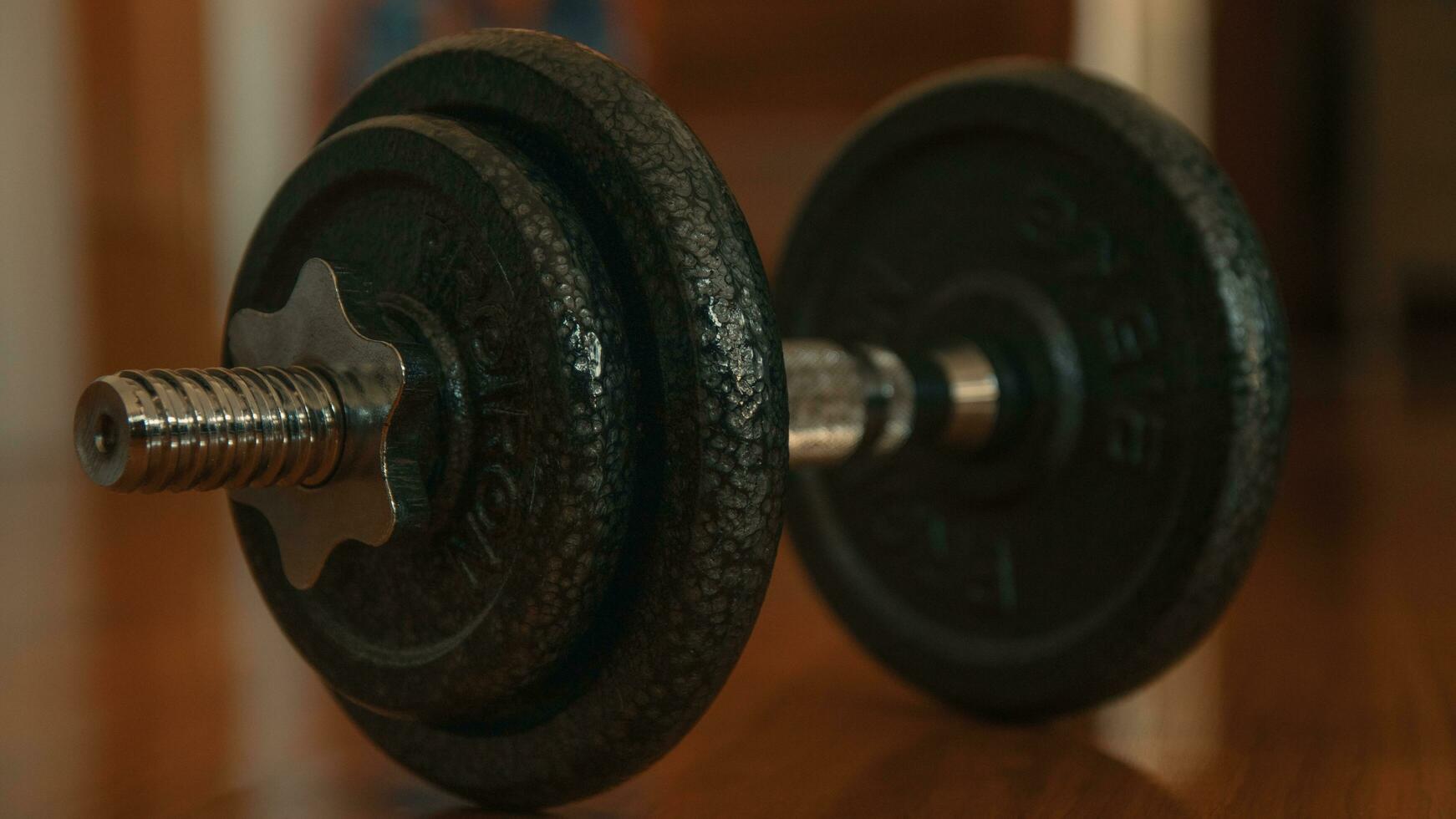 Dumbbells on a wooden floor. Close-up. photo