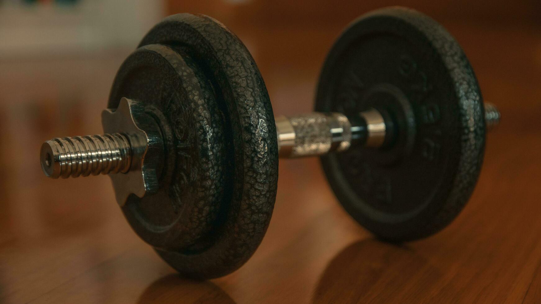 Dumbbells on a wooden floor. Close-up. photo