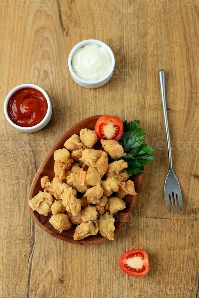 Crispy Popcorn Chicken with Mayonaise and Chilli Sauce. photo