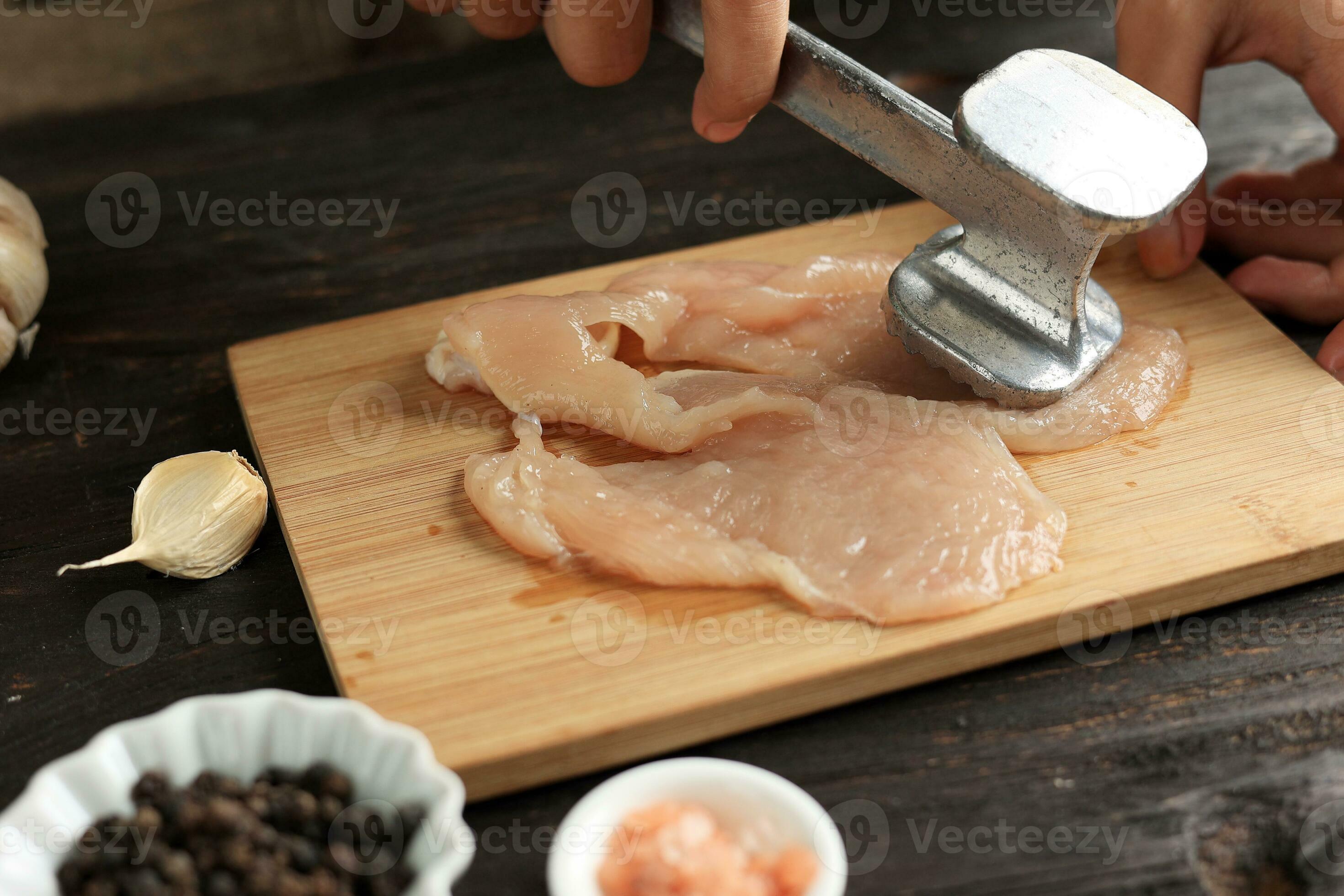 Beat Chicken using Meat Tenderizer 24502148 Stock Photo at Vecteezy