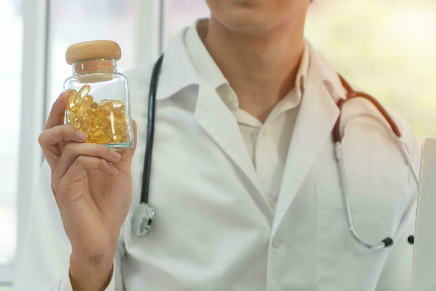 Pharmacist or Physician medicine doctor holding or showing a bottle of pills in hand after invented a new drug. Concept of  health insurance and medical care photo