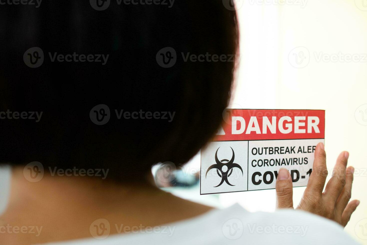 A Wife standing in front of the Quarantine room And put a hand on the mirror While waiting for the examination results, She has a lot of anxiety. Concept of Disease treatment and coronavirus vaccine photo