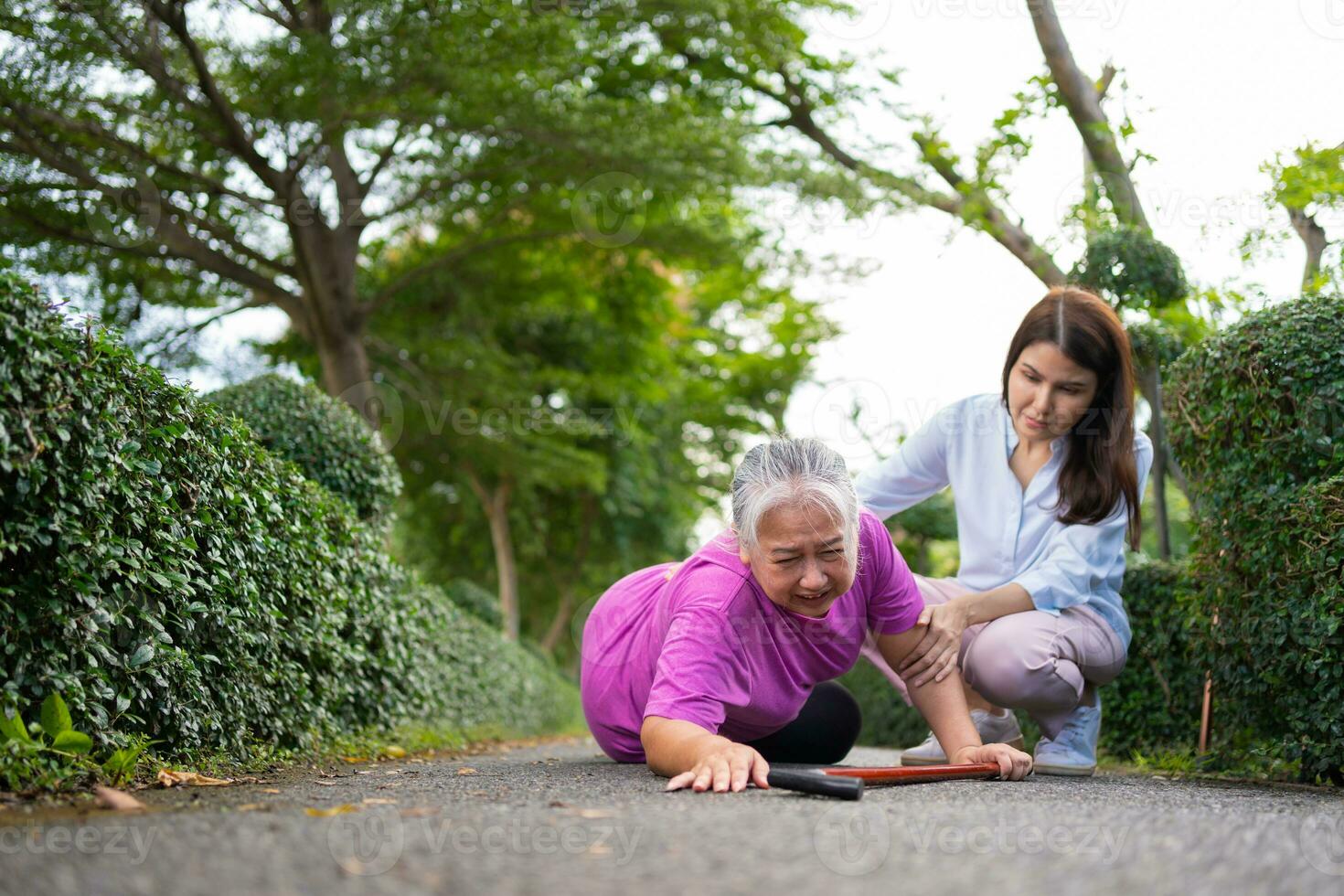 Asian senior woman fell down on lying floor because faint and limb weakness and Crying in pain form accident and her daughter came to help support. Concept of old elderly insurance and health care photo