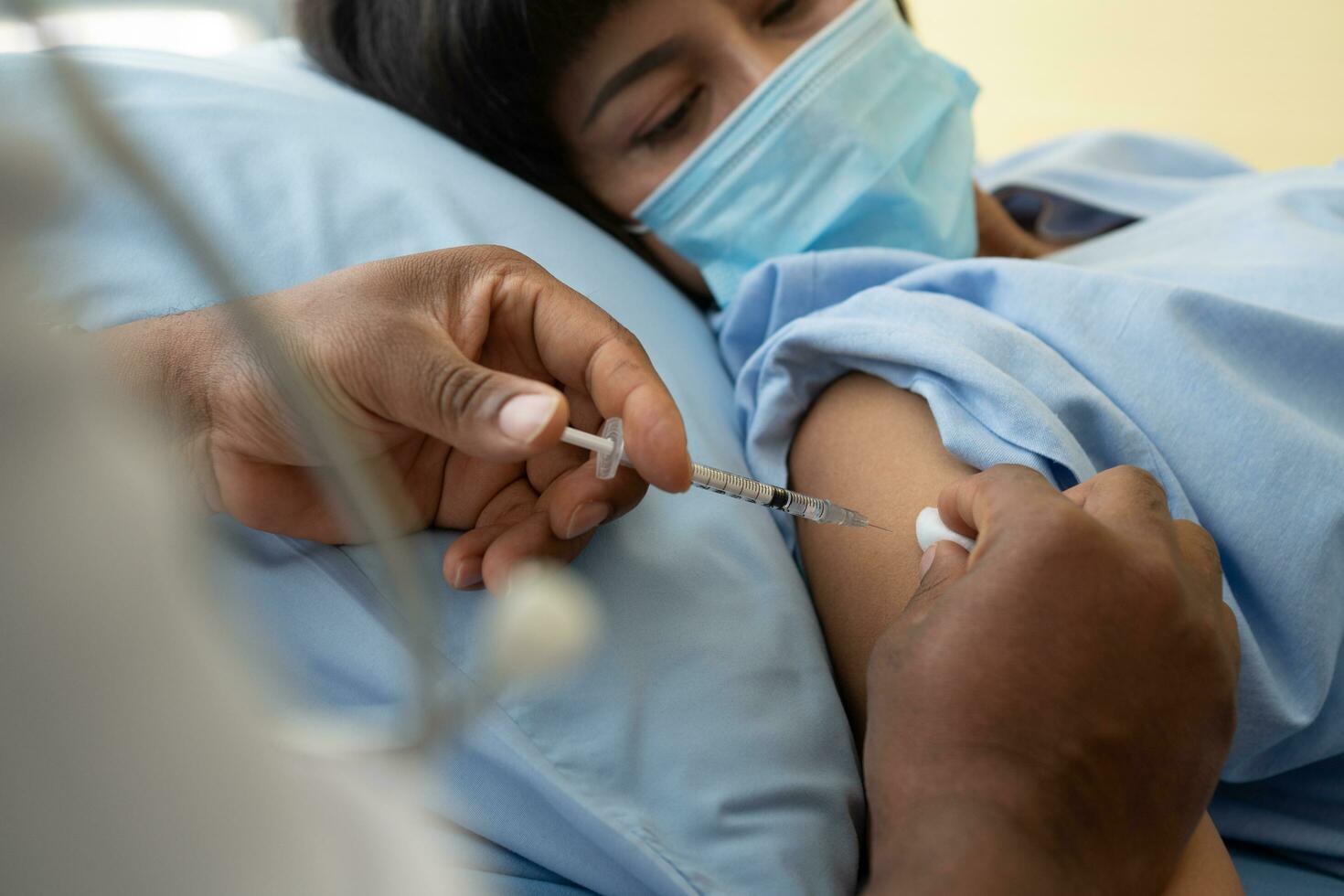 African American doctors wear medical masks and vaccinated to women patients for the prevention of coronavirus and flu. Concept of immunization from inoculation photo