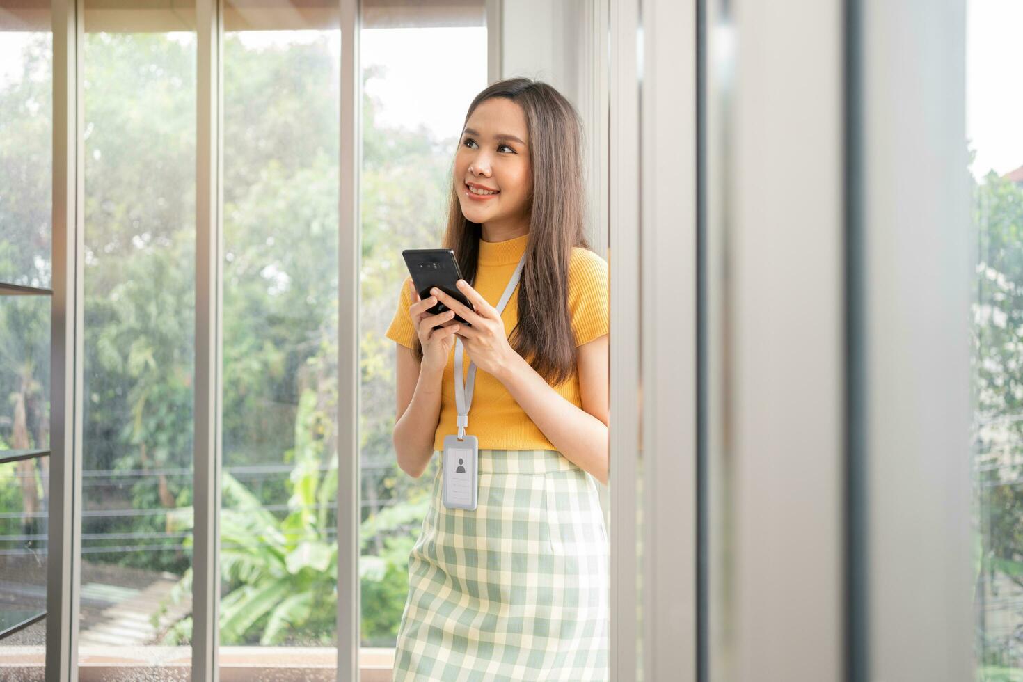 Happy young Asian women startup entrepreneur happy and excited smiling after getting message for success sign business contact, happy girl on workplace. Distance learning online education and work. photo