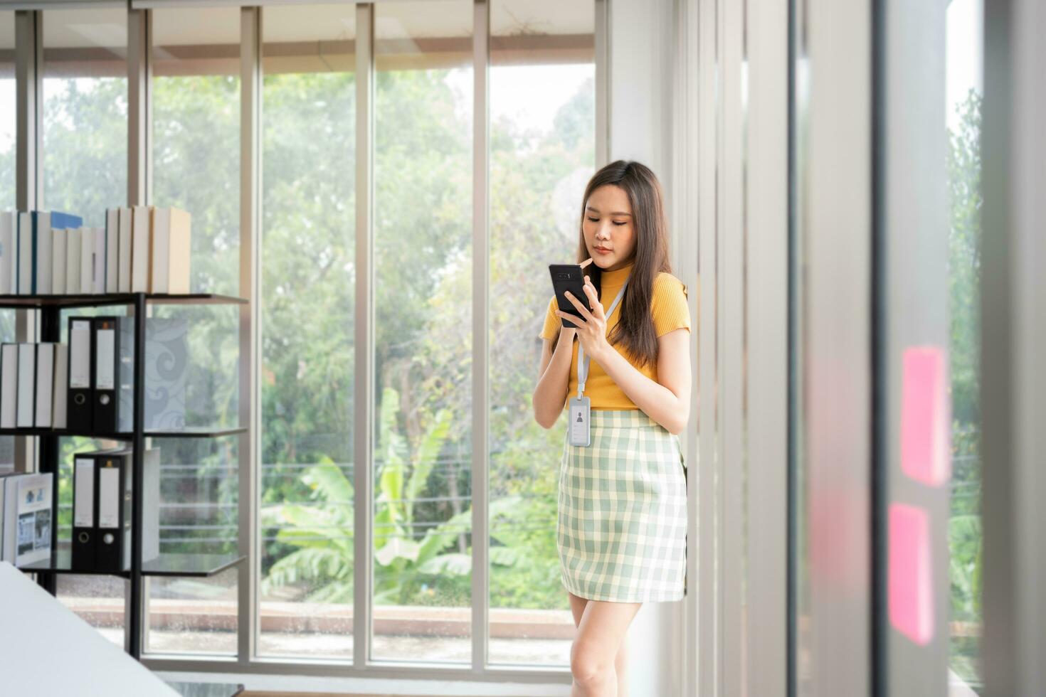 Happy young Asian women startup entrepreneur happy and excited smiling after getting message for success sign business contact, happy girl on workplace. Distance learning online education and work. photo