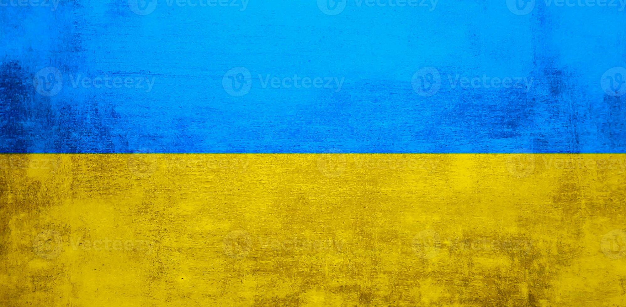The wall is in the colors of the Ukrainian national flag - blue and yellow. Abstract texture background of concrete stone wall. Ukrainian flag on a grunge wall in connection with the war with Russia. photo