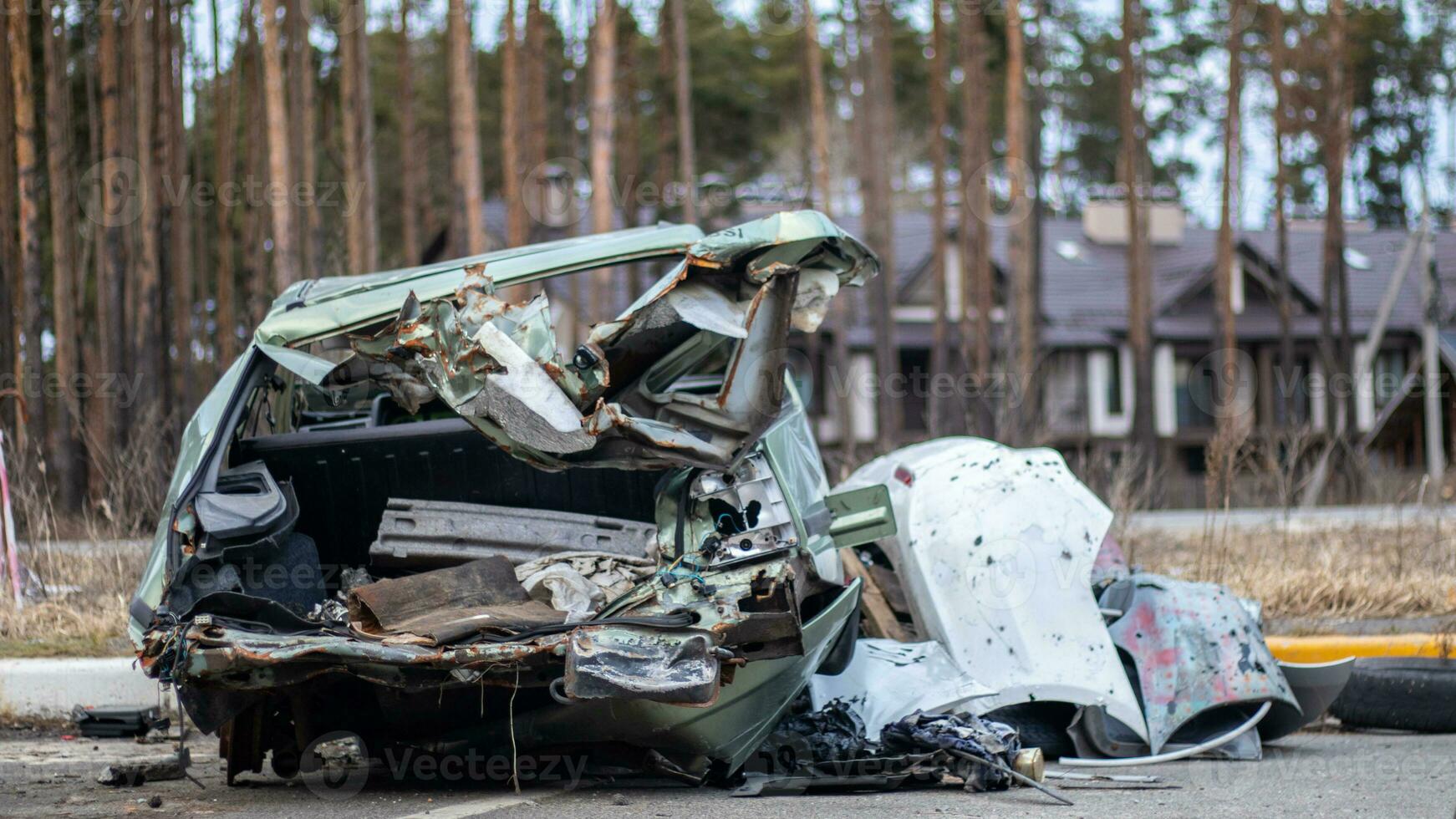 Broken crumpled car after a severe accident with a skewed body, after a powerful impact on the side of the road. Traffic accident on the street, damaged car after a collision in the city. photo