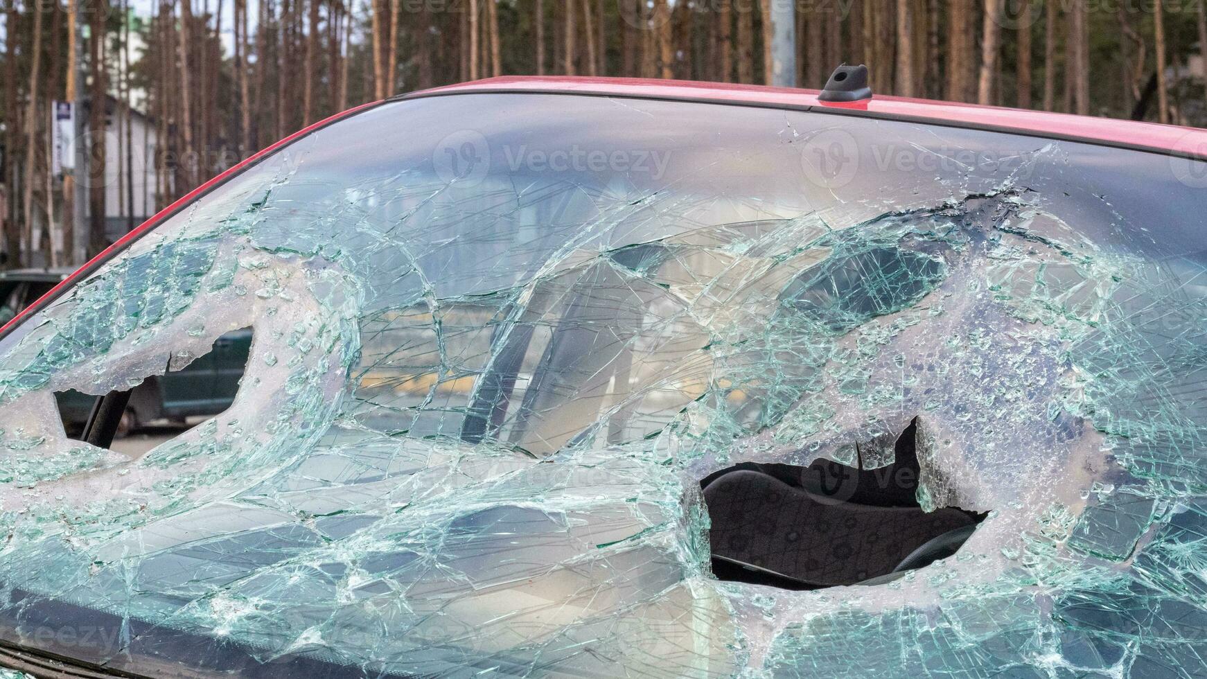 Broken windshield from a car accident. The windshield of the car was broken. Broken windproof car accident. Car accident. A window repair company will come to you to replace the broken glass. photo