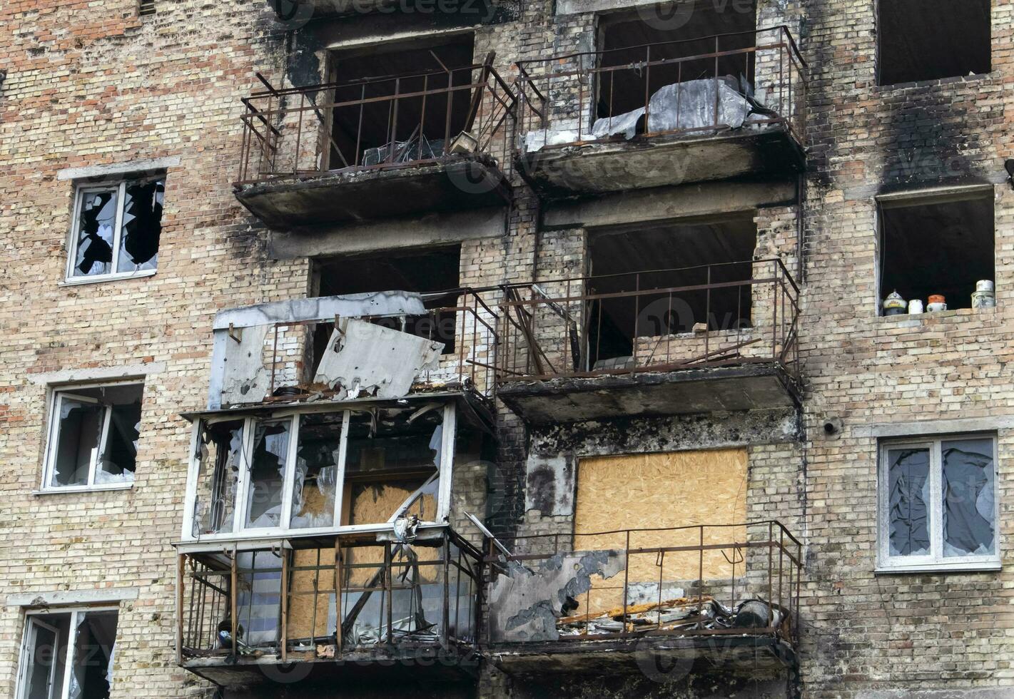 Consequences of the war in the capital of Ukraine. A bombed-out building damaged by shells after an airstrike. The rocket blew up the house. Holes in the walls from shells. photo