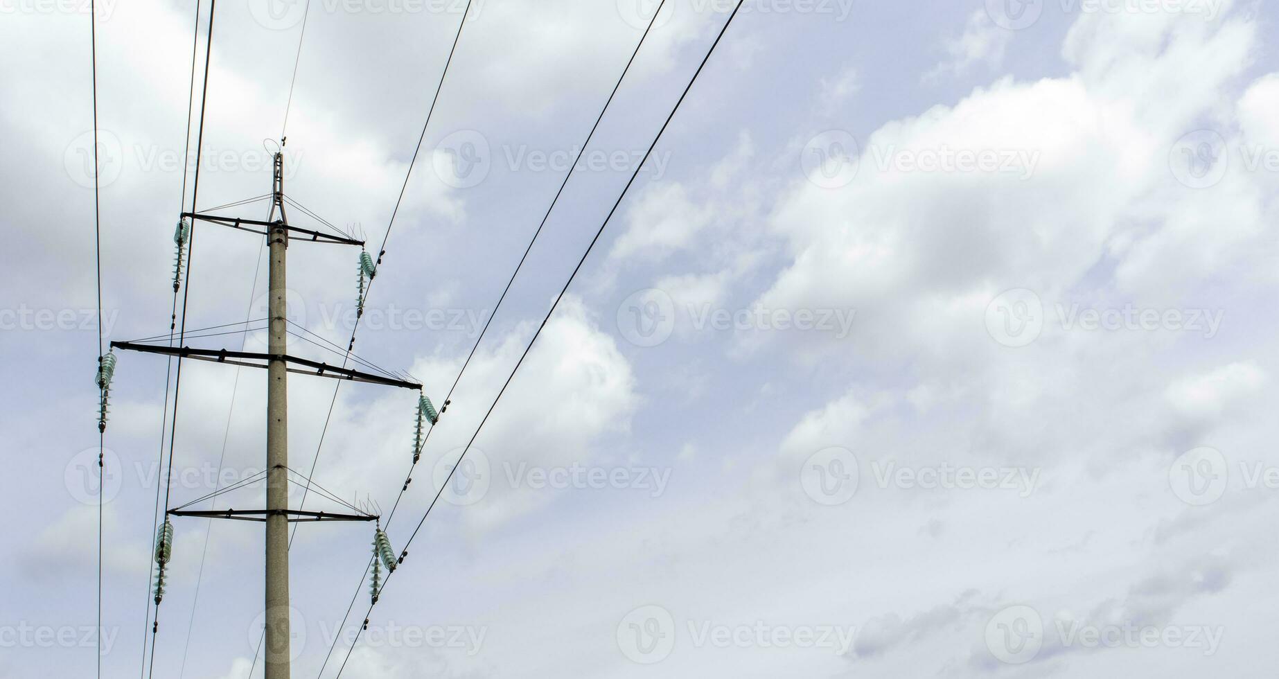 High voltage electrical tower against the sky. High voltage power lines. Electrical distribution station. The passage of the overhead line wire supports carrying light and heat into the house. photo