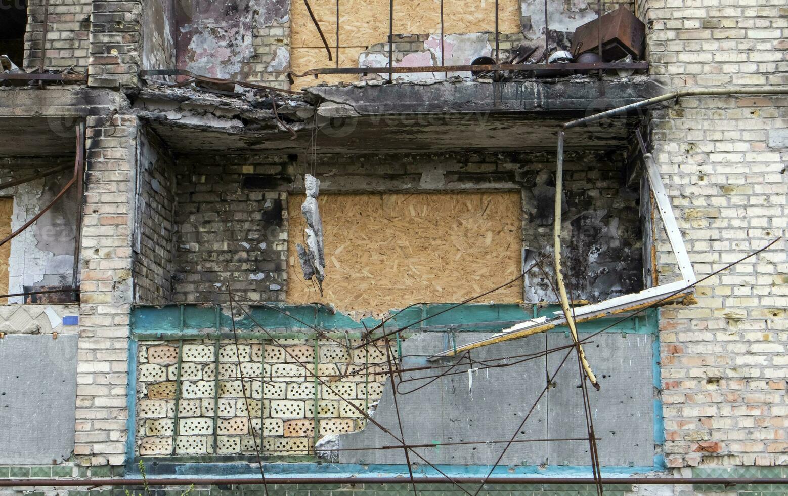 Burnt apartments in a multi-storey residential building, the consequences of the war in Ukraine. Buildings damaged by shells. Real creepy footage of the war in Ukraine. The rest of the property. photo