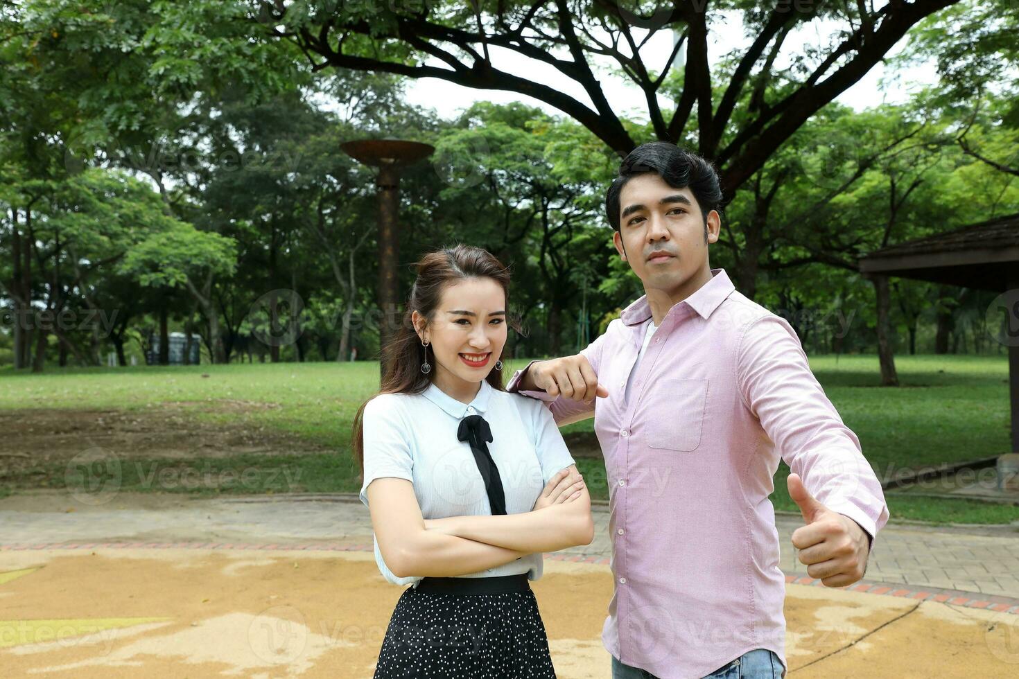 Young asian malay chinese man woman outdoor park  book file folder laptop computer phone sit stand study mingle photo