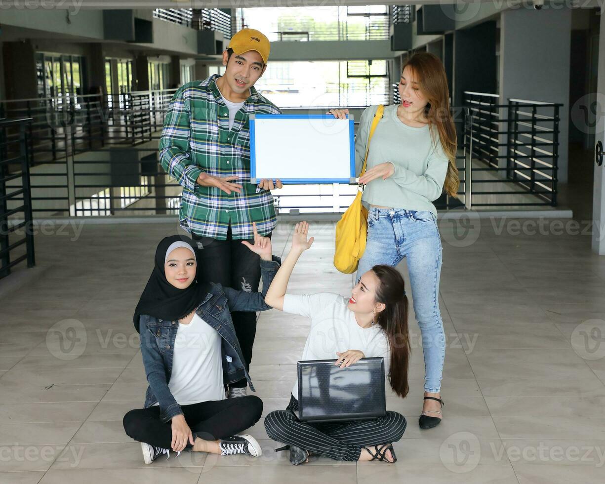 Young asian malay chinese man woman indoor stair corridor campus book file folder laptop computer phone sit stand study mingle photo