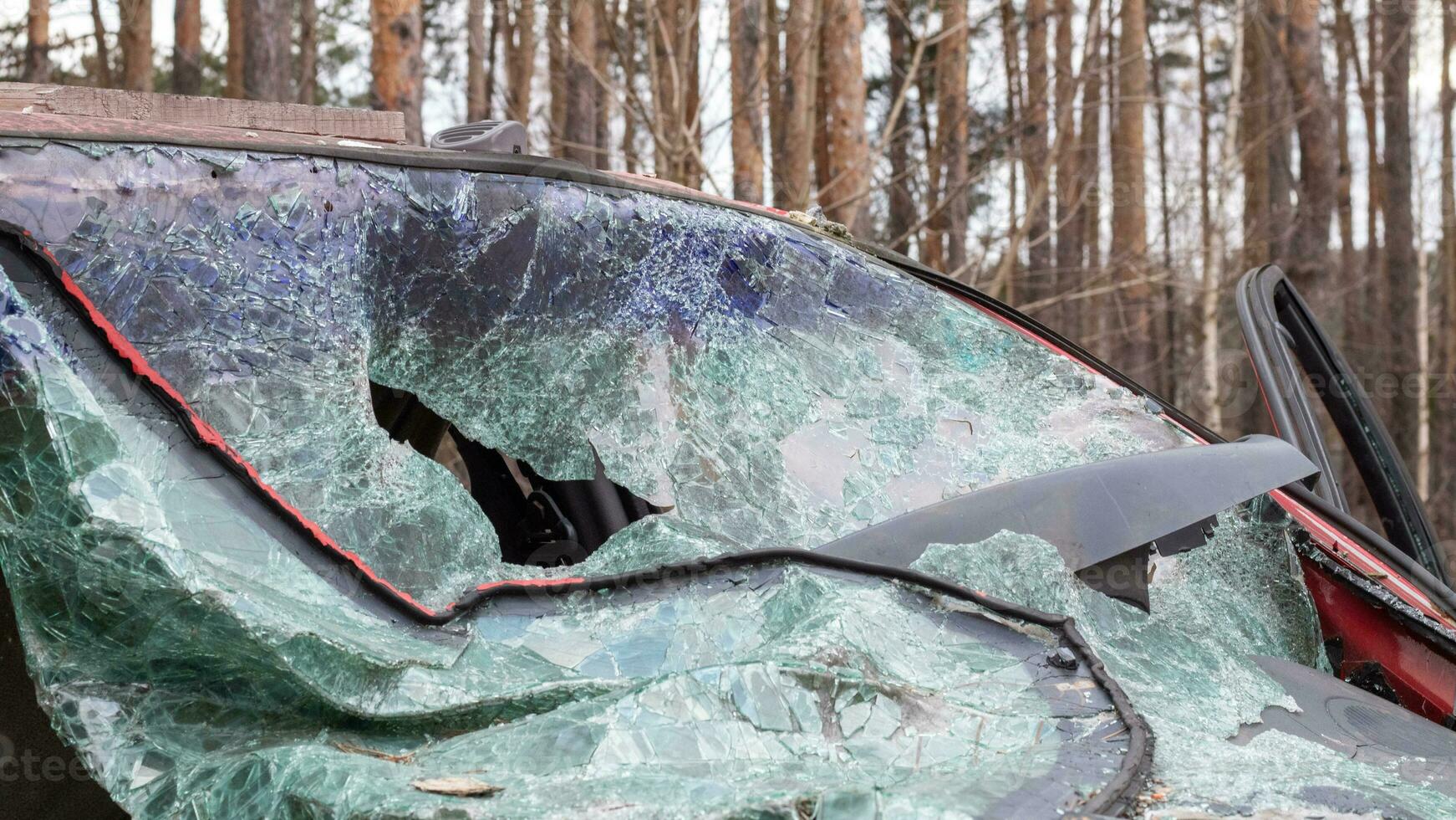 Broken windshield from a car accident. The windshield of the car was broken. Broken windproof car accident. Car accident. A window repair company will come to you to replace the broken glass. photo