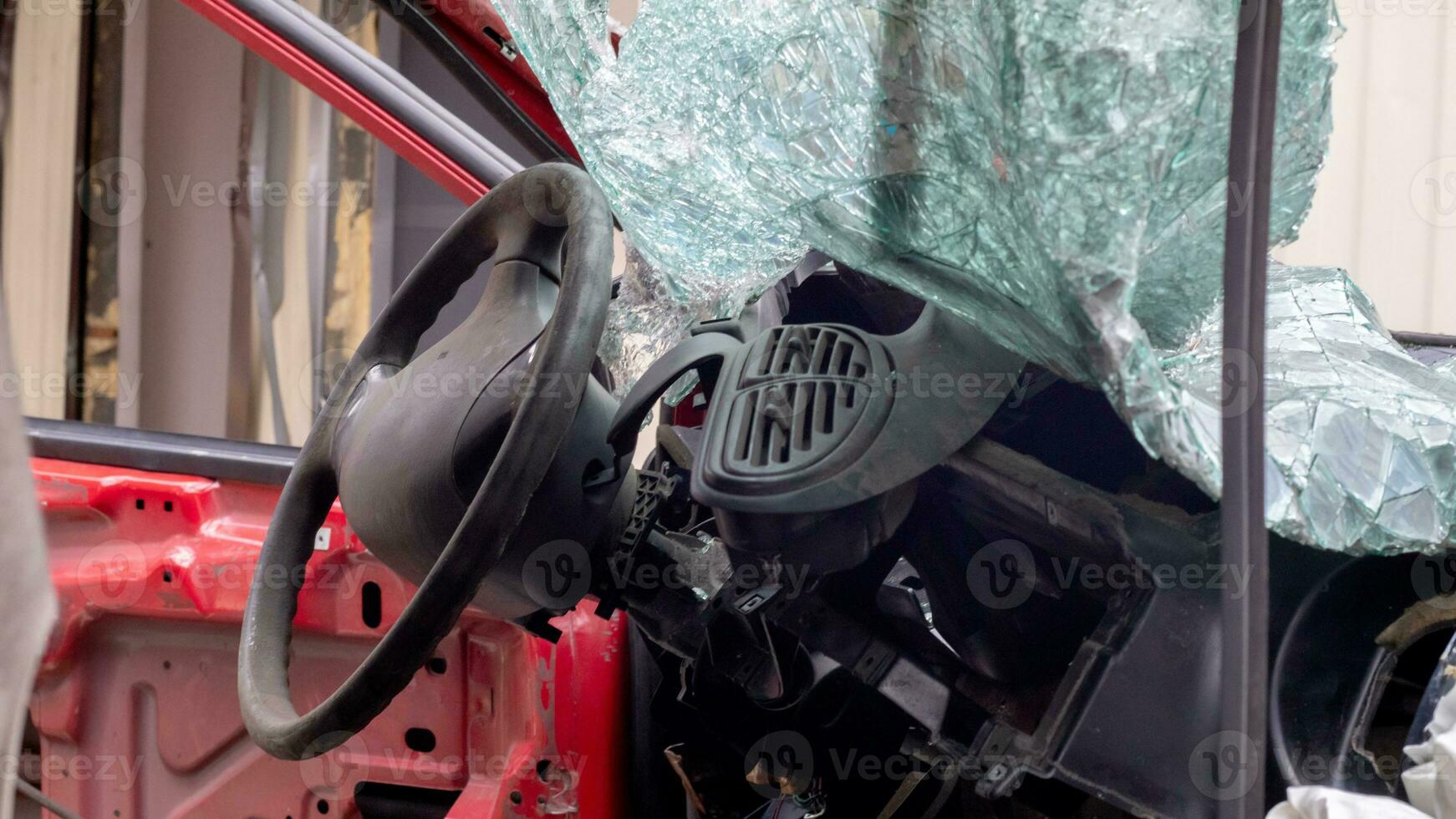 Broken rumpled red car after a severe accident with a skewed body, after a powerful blow. Accident on the street, damaged car after a collision in the city. Auto accident. Broken car on the street. photo