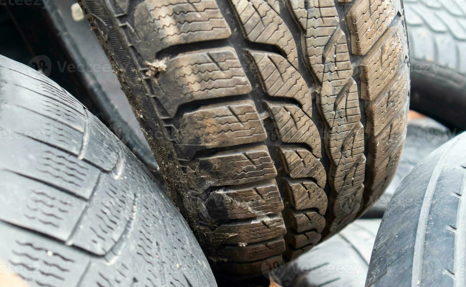 Industrial landfill for recycling used tires and rubber tires. Old used tires. A dump full of used car tires. The concept of recycling and environmental protection. photo