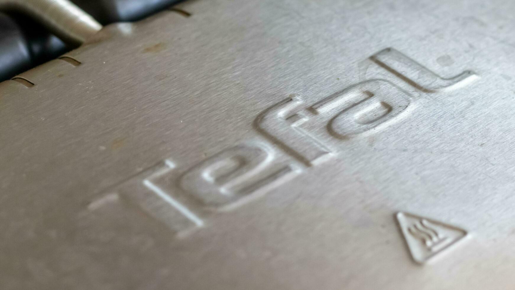 Tefal logo on electric grill. Stainless steel, special non-stick coating. Ukraine, Kyiv - October 9, 2022. photo