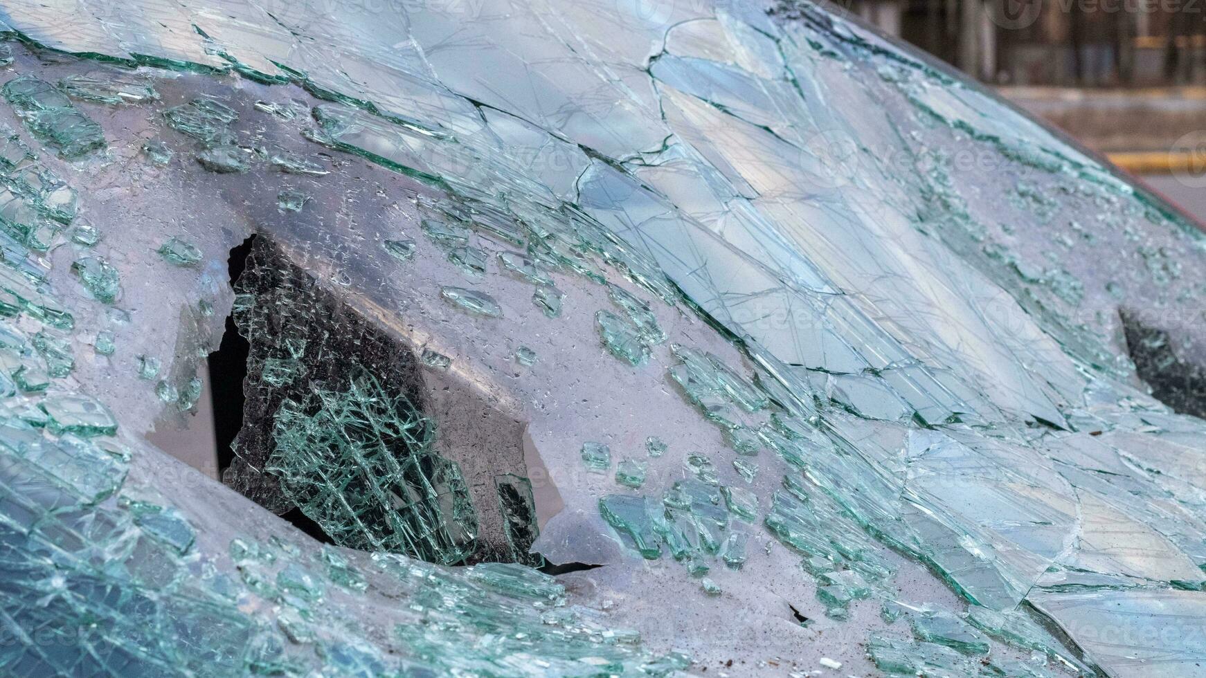 Broken windshield from a car accident. The windshield of the car was broken. Broken windproof car accident. Car accident. A window repair company will come to you to replace the broken glass. photo