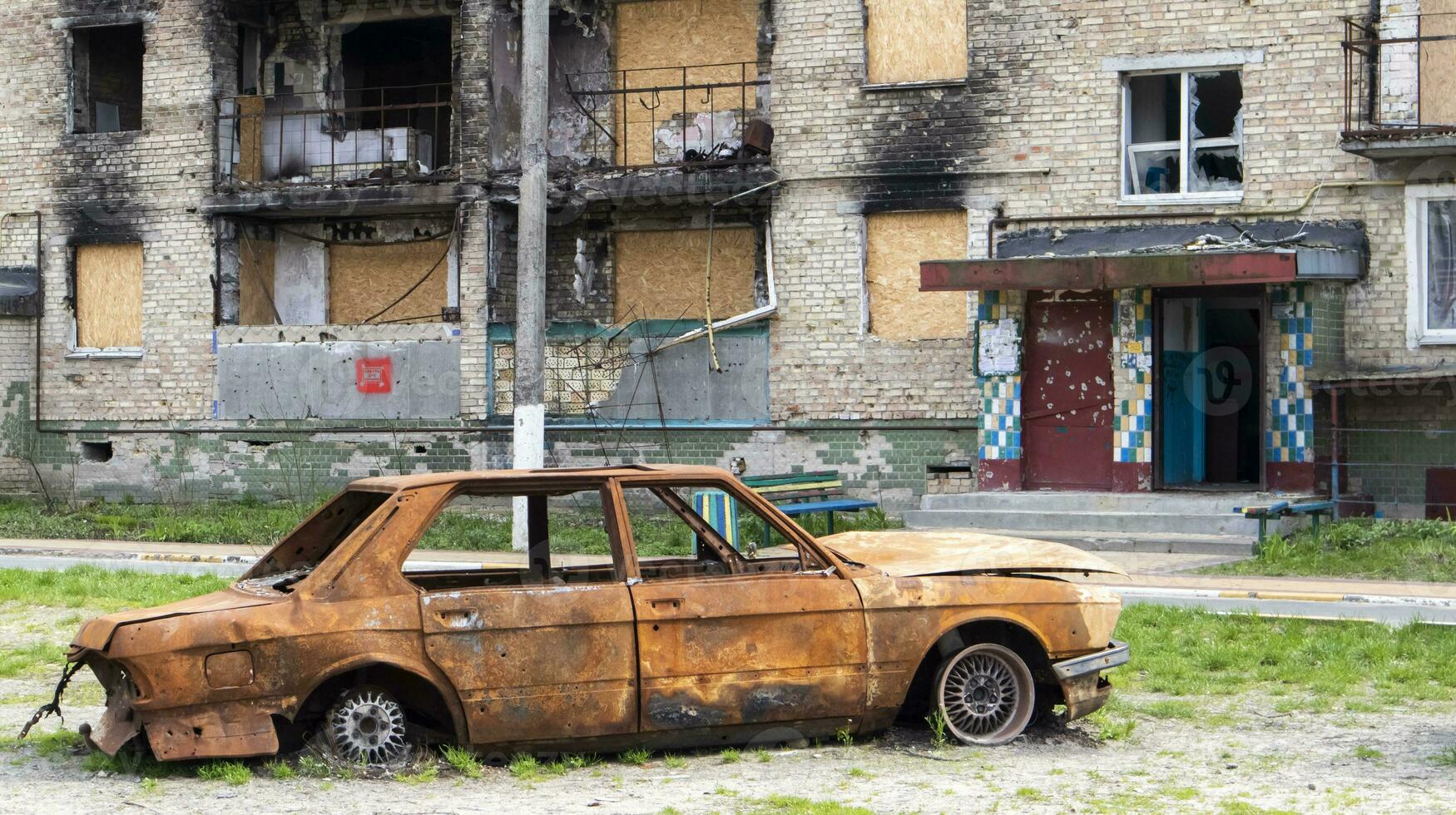 Burnt apartments in a multi-storey residential building, the consequences of the war in Ukraine. Buildings damaged by shells. Real creepy footage of the war in Ukraine. The rest of the property. photo