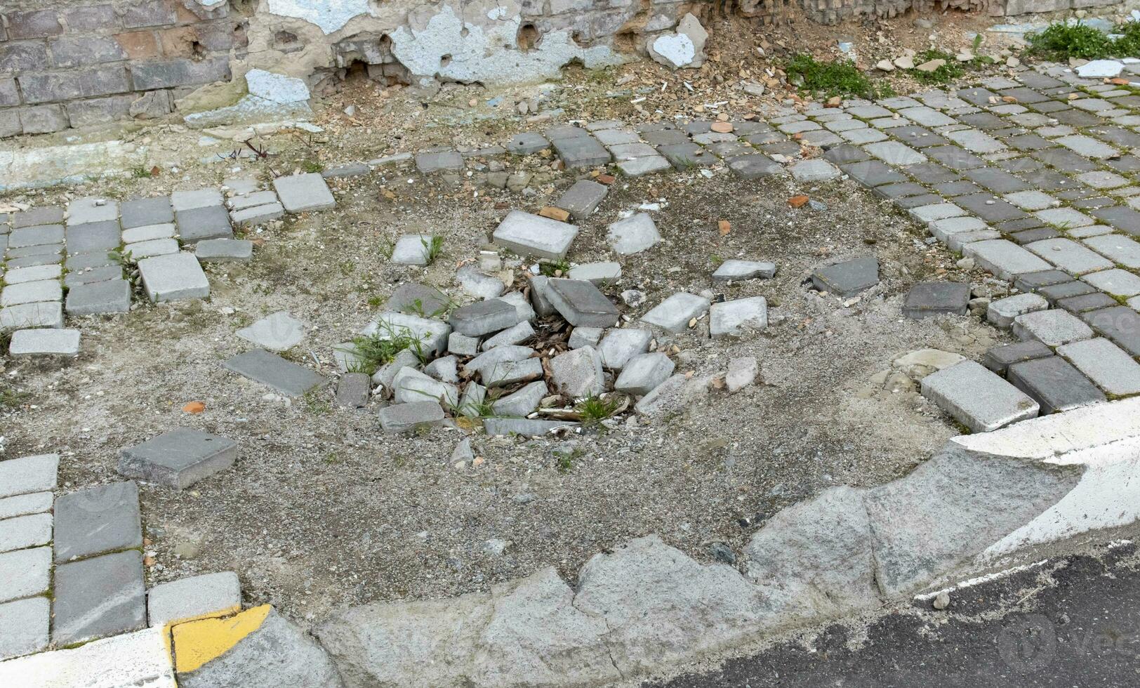 War in Ukraine. Funnel from the explosion in the asphalt. The trace left by the explosion of an artillery shell. Consequences of the rocket attack. Drone attack. photo