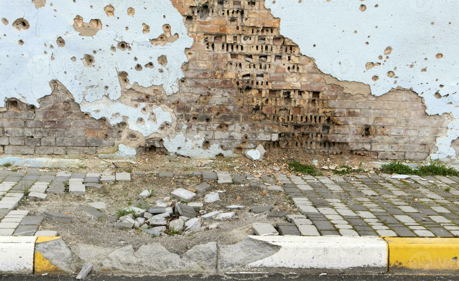 War in Ukraine. Funnel from the explosion in the asphalt. The trace left by the explosion of an artillery shell. Consequences of the rocket attack. Drone attack. photo