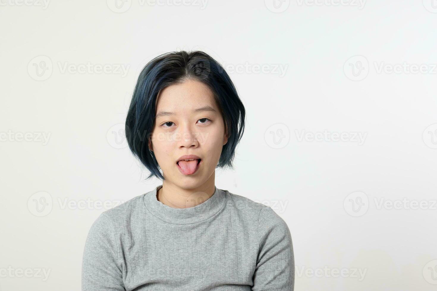 Young attractive Asian chinese malay woman pose face body expression mode emotion on white background tired tongue out photo