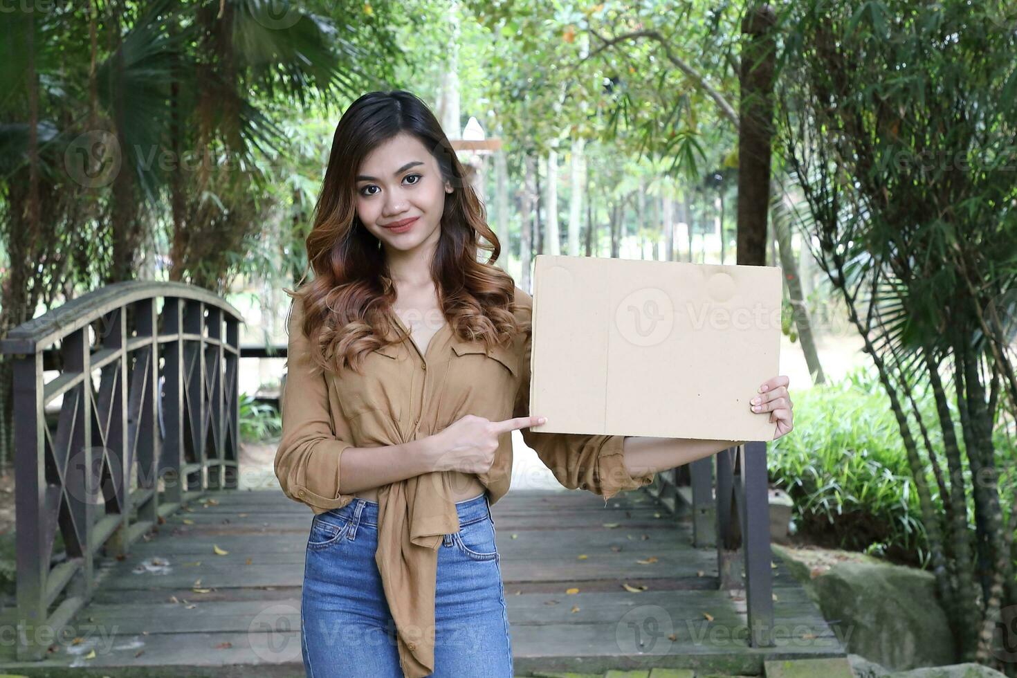 Young Asian Malay man woman outdoor green park walk talk discuss mingle photo