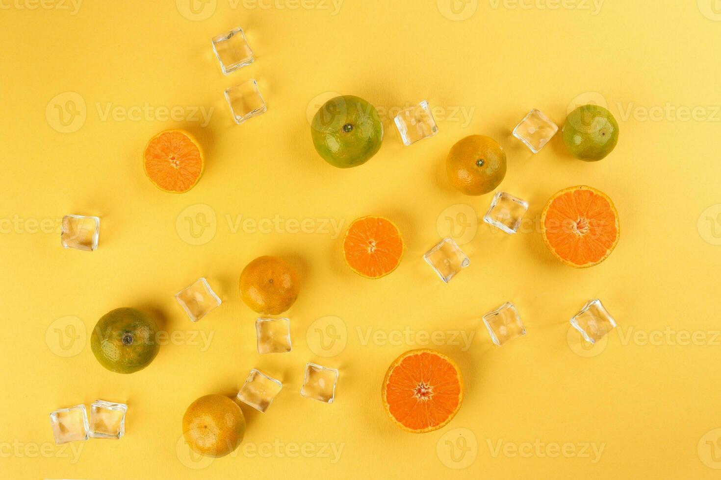 small yellow green mandarin ice cube orange whole slice on yellow background copy space for text photo