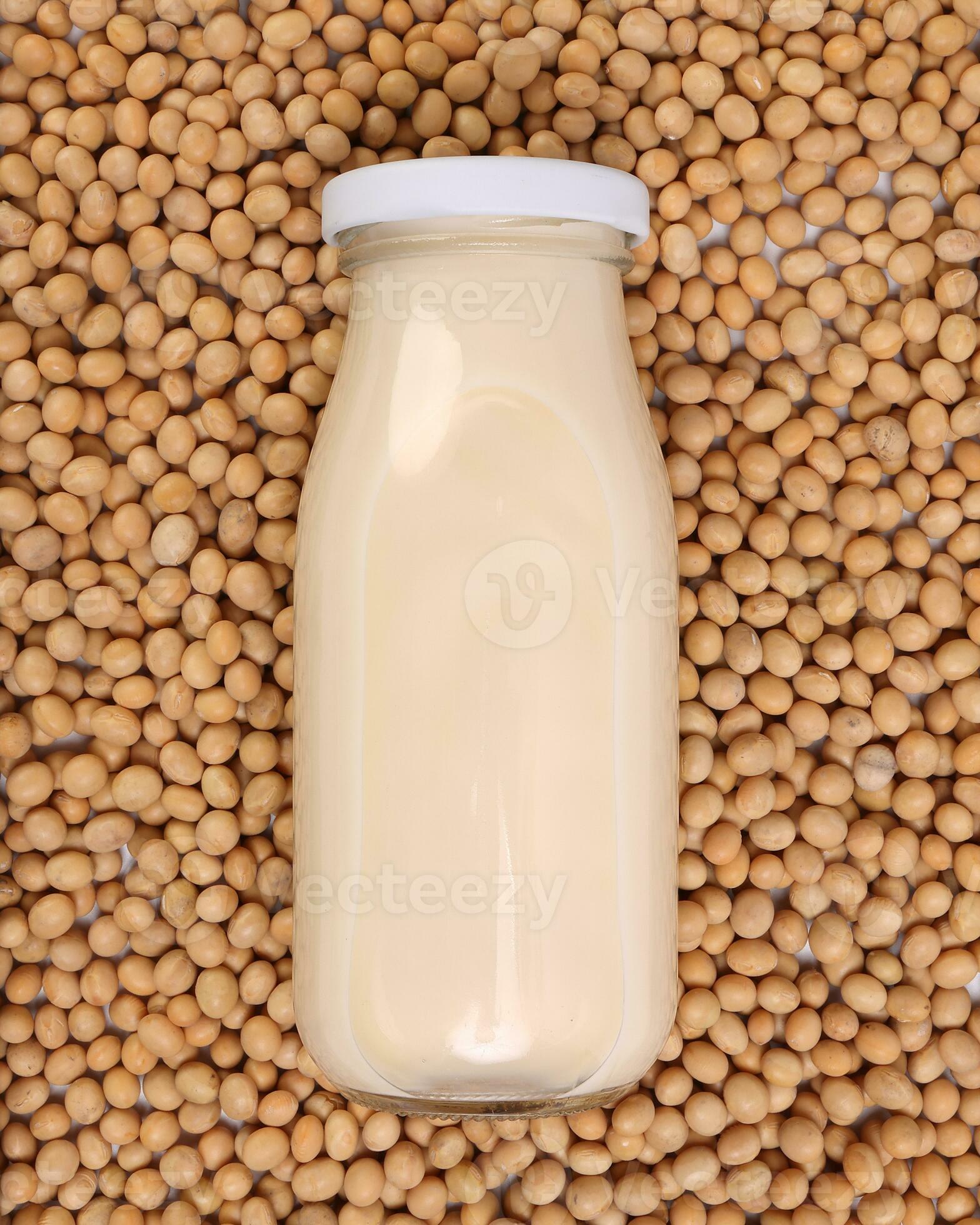 Soya milk in glass bottle on bed of soyabean background 24510886 Stock