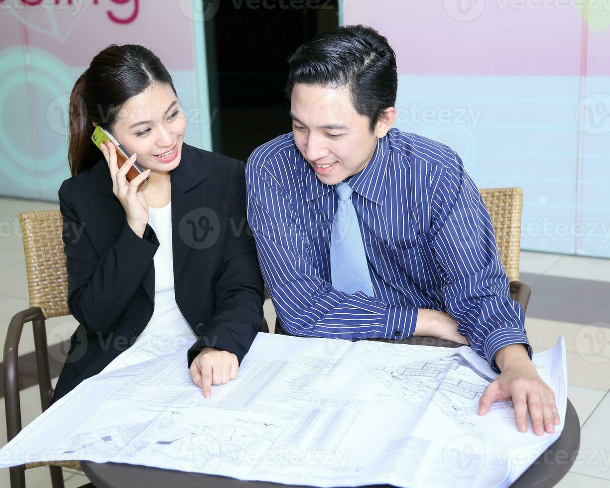South East Asian young Malay Chinese man woman wearing safely helmet construction site work photo