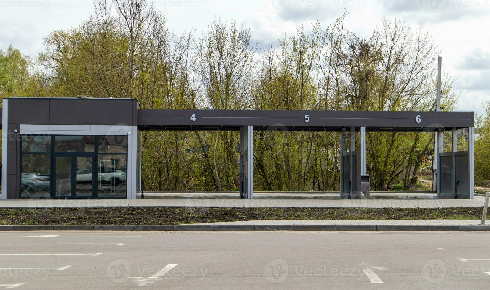 Self-service high-pressure car wash in the open air. Photo of an open self-service car wash. Manual car wash with pressurized water in a car wash outside.