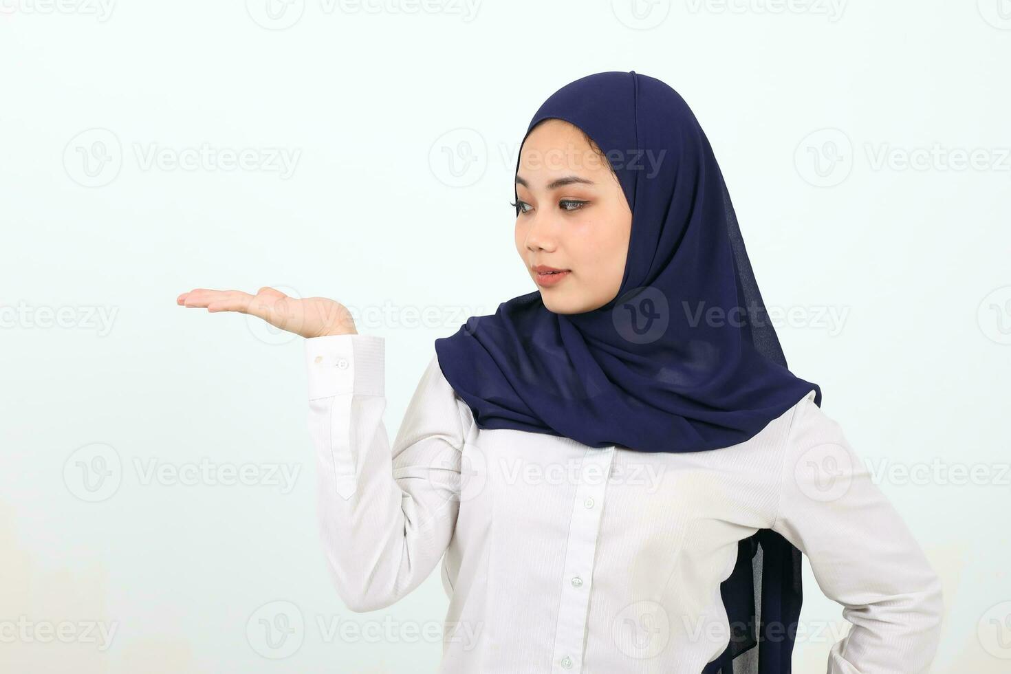 South east Asian Malay Woman headscarf facial expression show point palm of hand photo