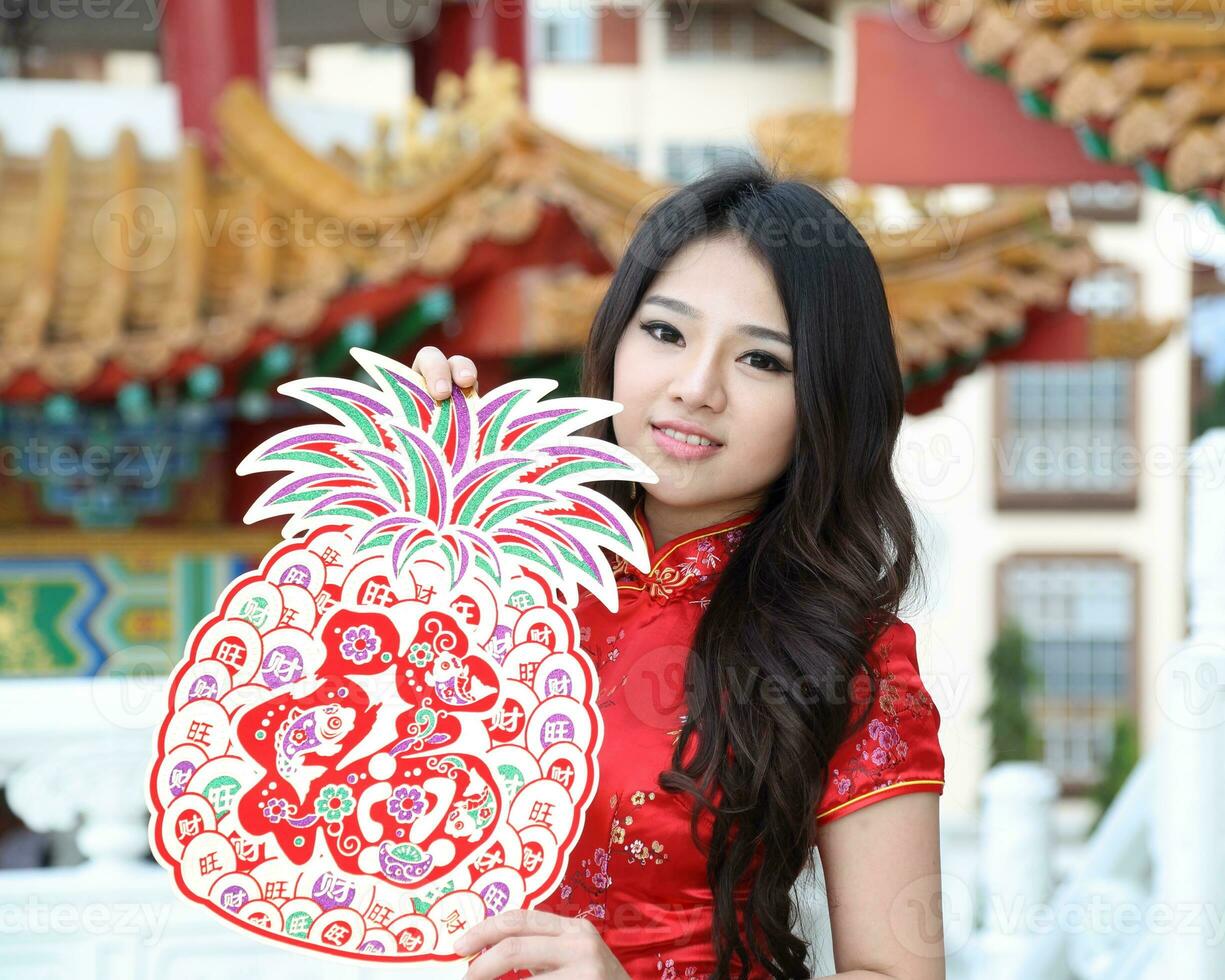 Young south east asian Chinese man woman traditional costume Chinese new year greeting outdoors at temple photo