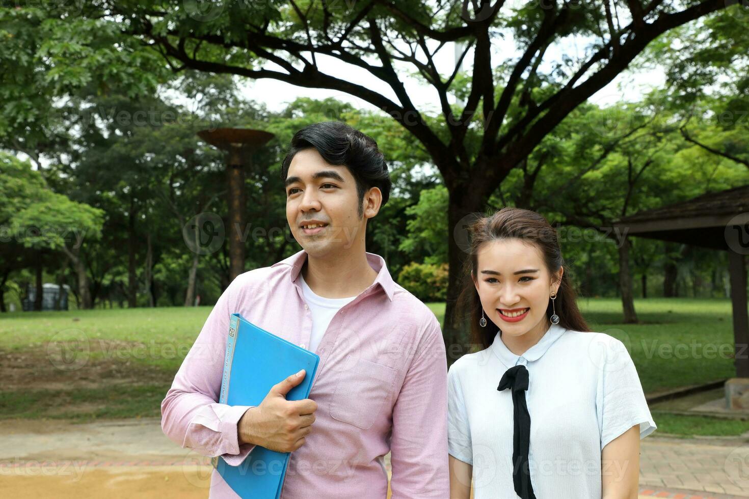 young asian malay chinese man woman outdoor park walk stand study talk discuss laptop file book backpack pose happy mingle look forward photo