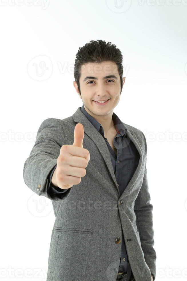Middle eastern Caucasian young office business man wearing suit thumbs up look at camera on white studio background photo
