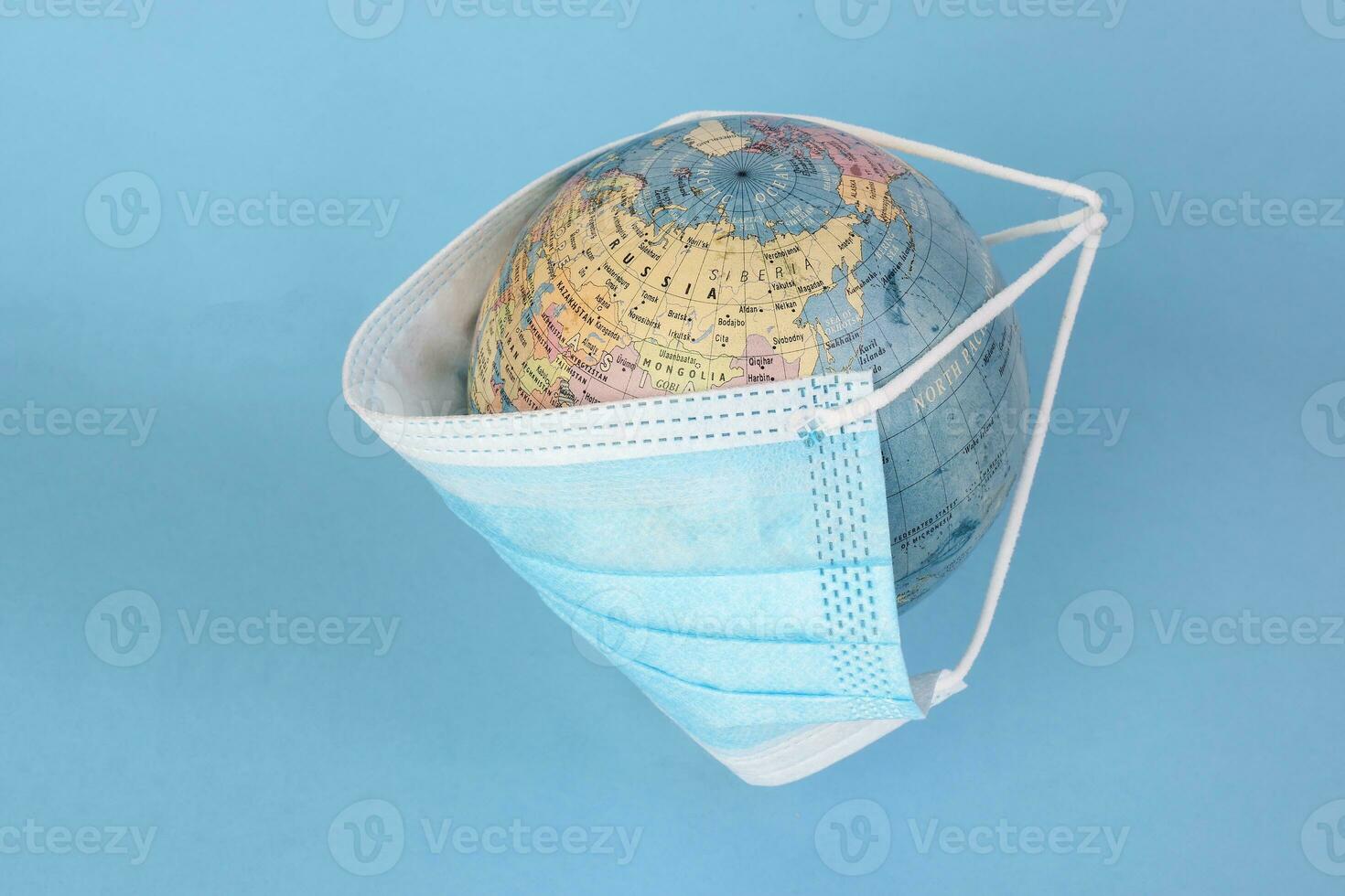 globe planet world map earth wearing face mask on blue background photo
