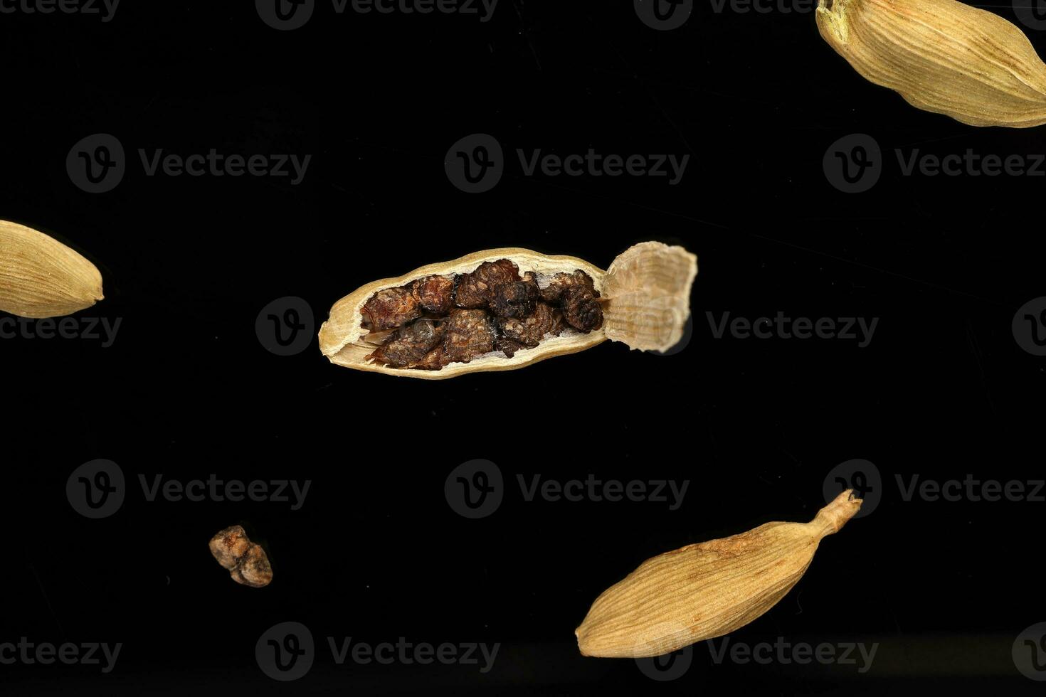 Cardamom fragrant spice seed closeup macro on black background photo