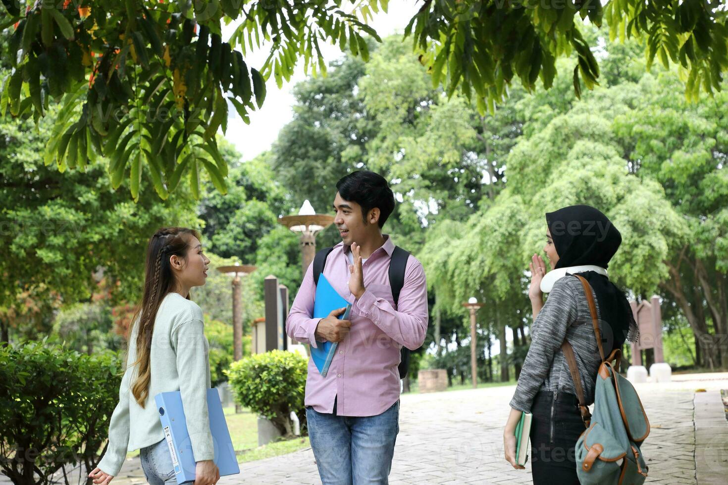 Young asian malay chinese man woman indoor stair corridor campus book file folder laptop computer phone sit stand study mingle photo