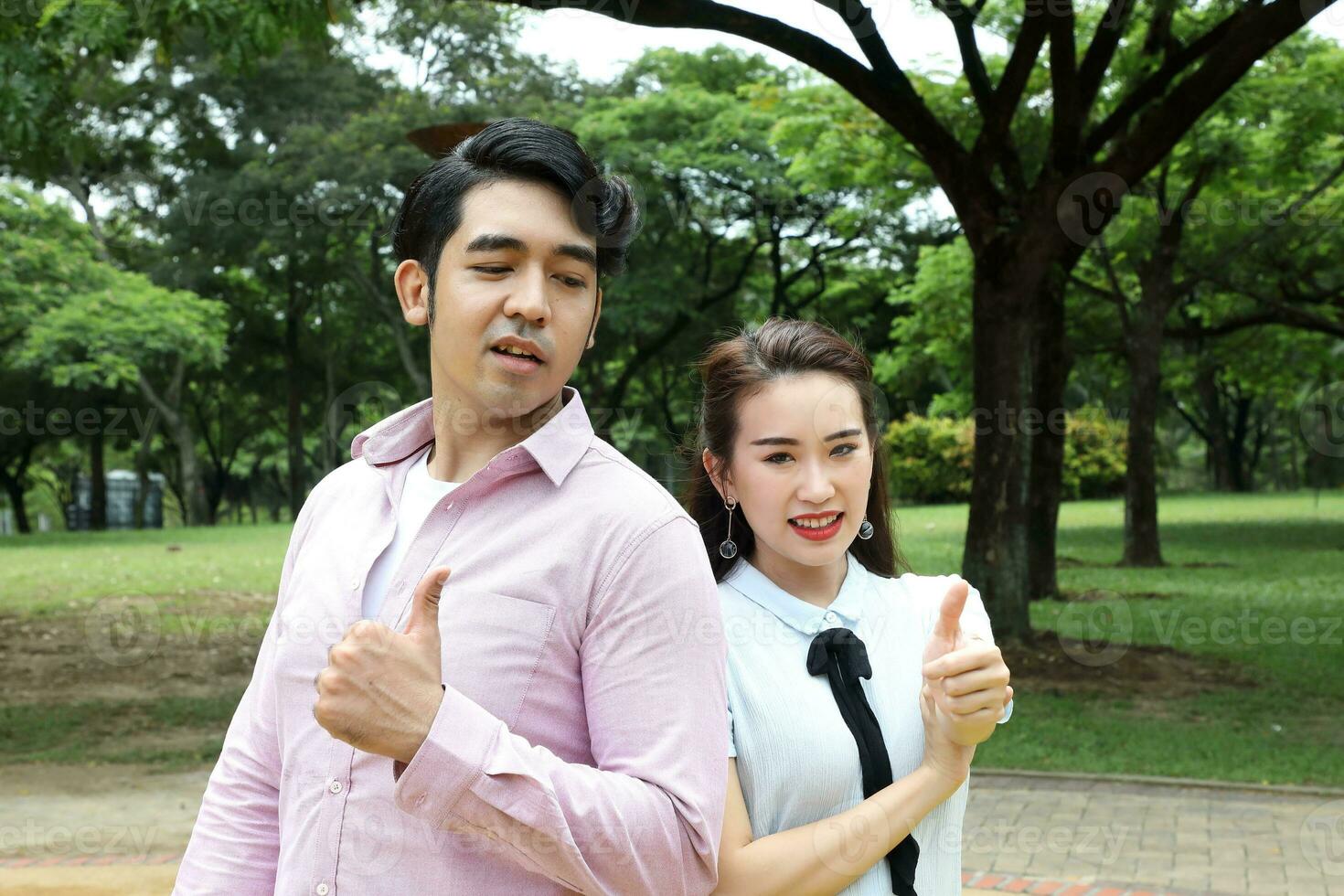 Young asian malay chinese man woman outdoor park  book file folder laptop computer phone sit stand study mingle photo