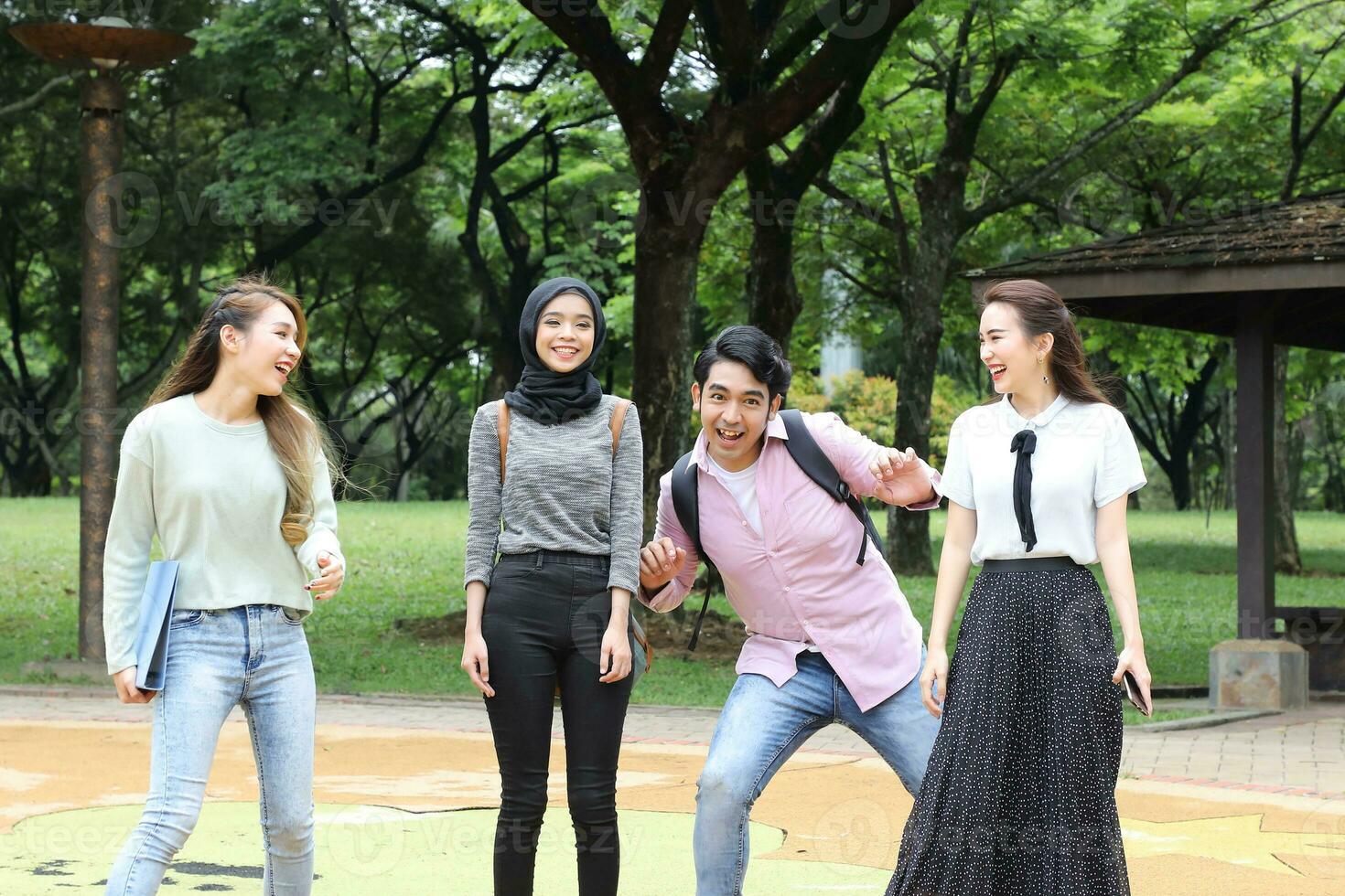 Young asian malay chinese man woman outdoor park  book file folder laptop computer phone sit stand study mingle photo