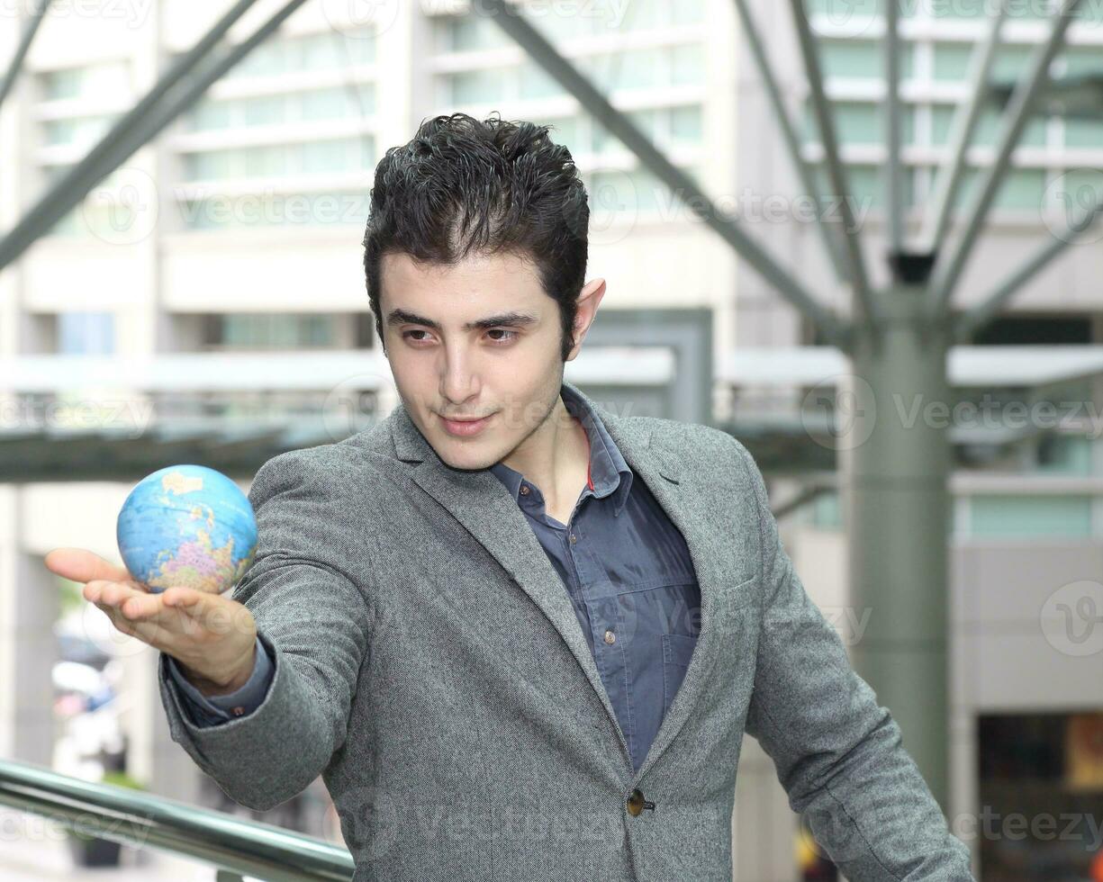 Young south east Asian middle eastern man woman student business colleague globe photo