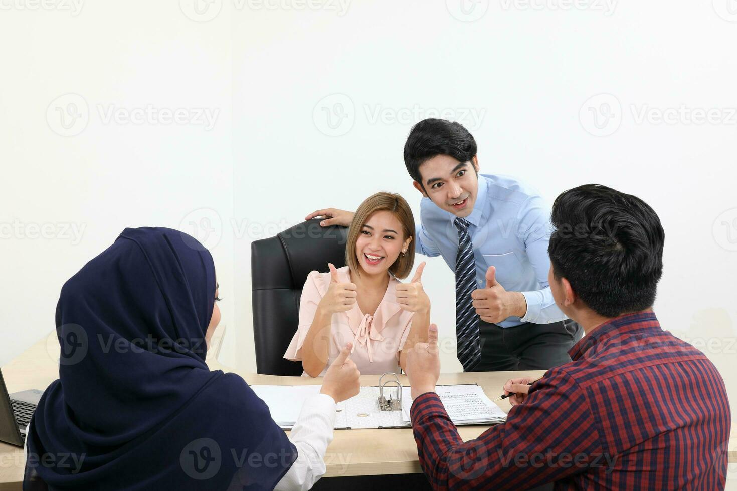 Asian young man woman malay chinese office table sit stand client couple meeting talk discuss show see point explain file document folder photo