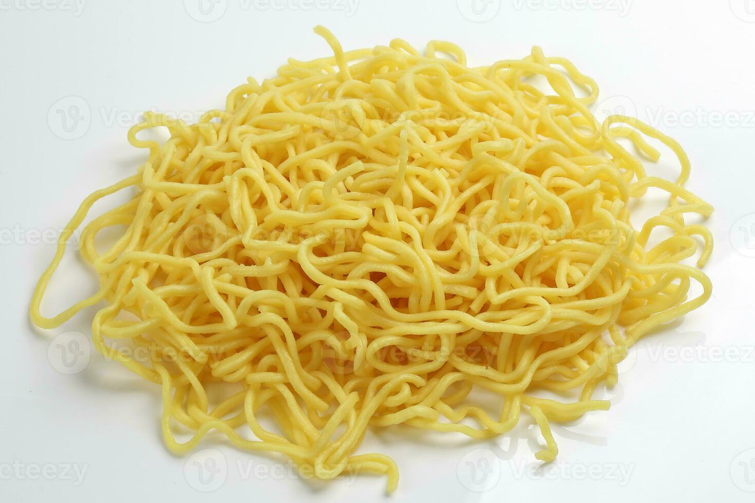 Fresh yellow egg noodle on whit background photo