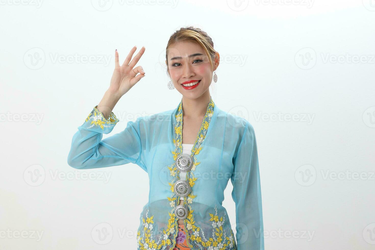Asian woman traditional blue orange kebaya sharong on white  background finger ok sing photo